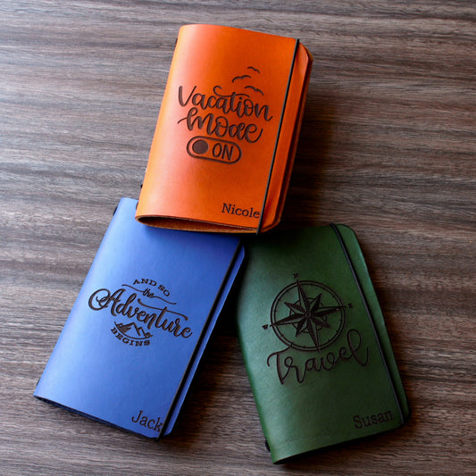 Personalized brown full-grain leather passport cover with laser engraved Vacation Mode On design, elastic band closure, and custom name Nicole engraved at bottom corner.