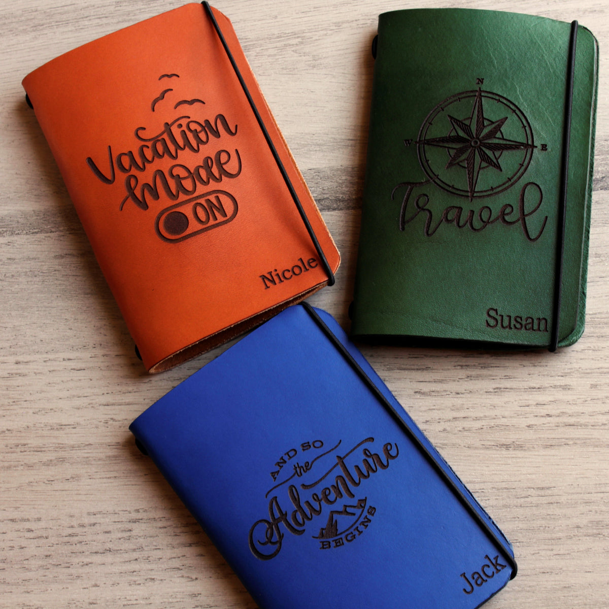 Personalized brown full-grain leather passport cover with laser engraved Vacation Mode On design, elastic band closure, and custom name Nicole engraved at bottom corner.